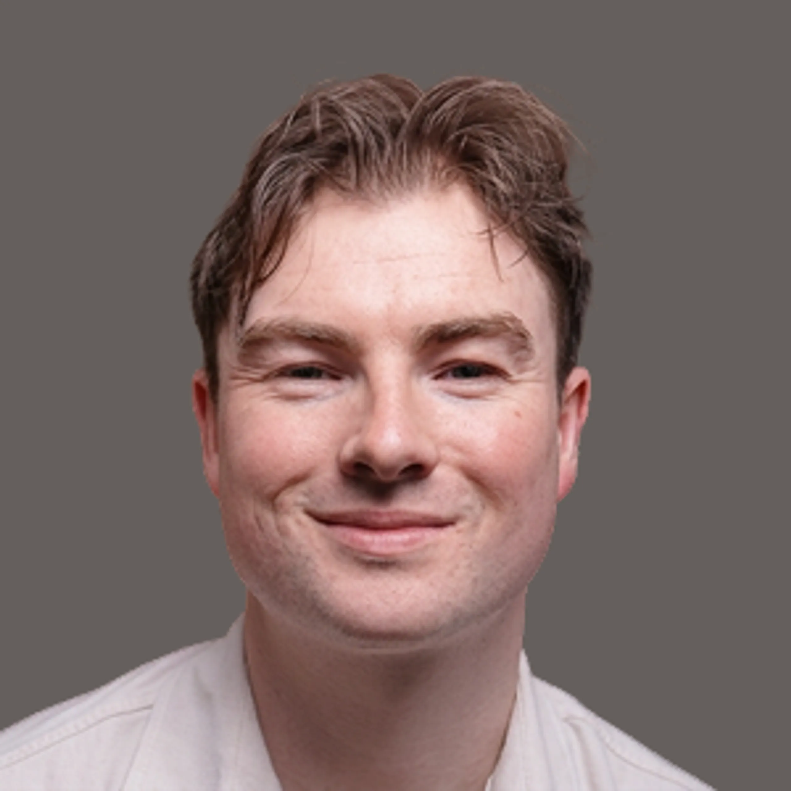 Headshot of a man smiling at the camera.