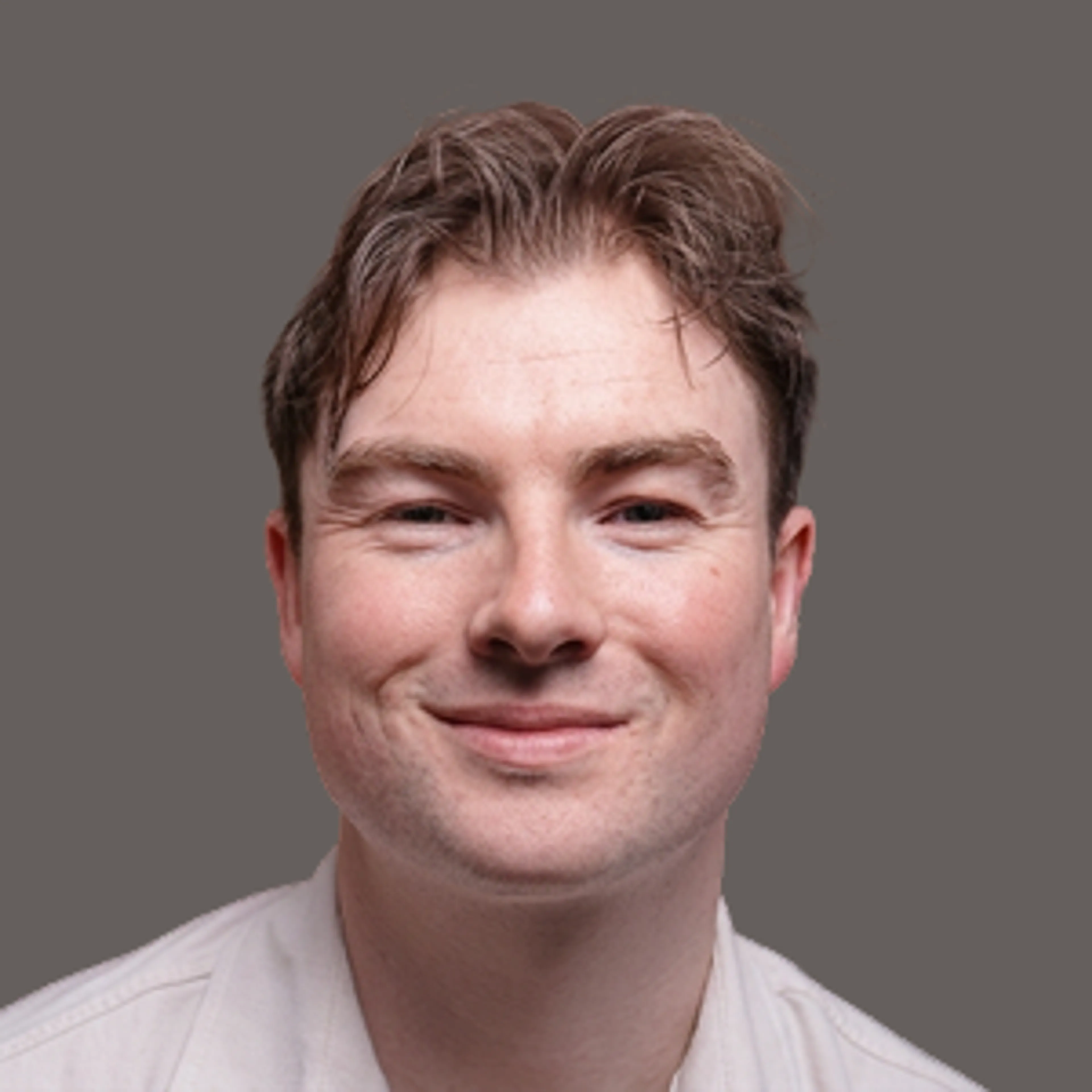 Headshot of a man smiling at the camera.