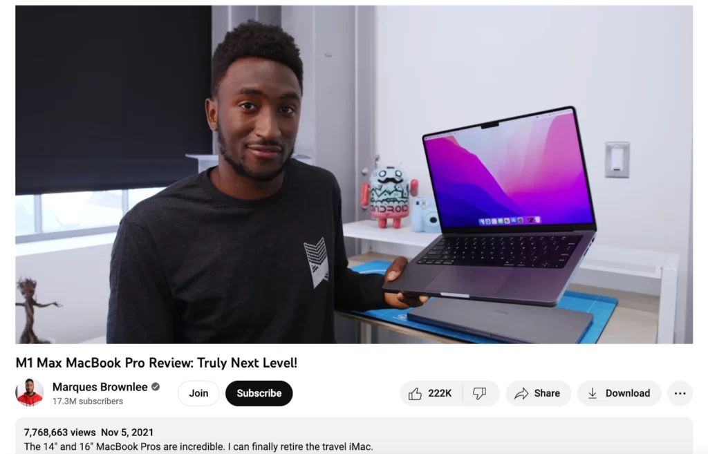 An image of Marques Brownlee holding a MacBook Pro