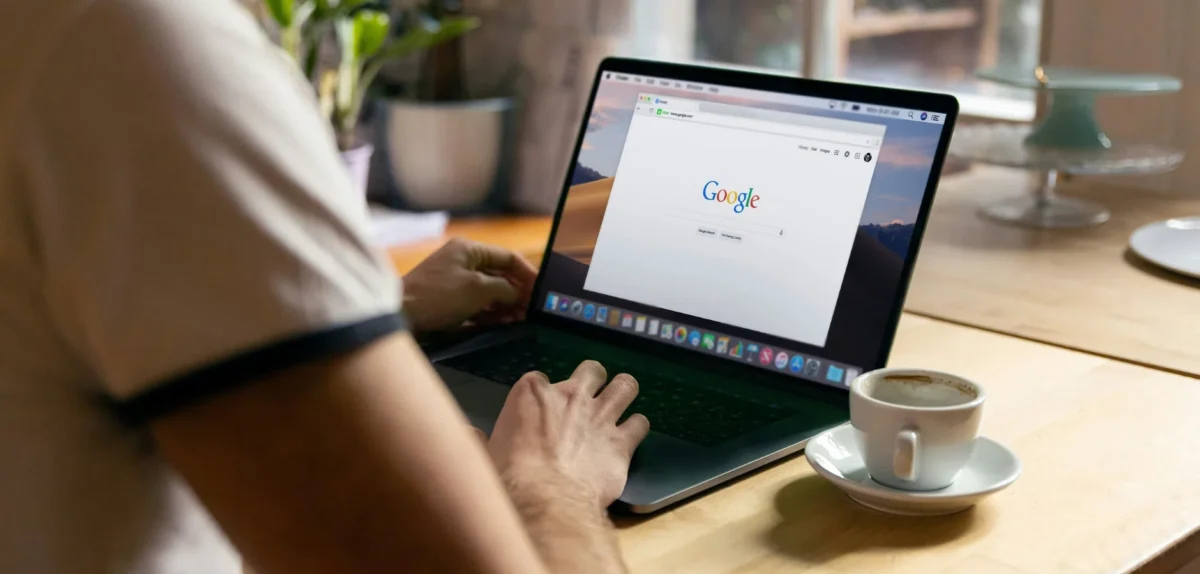 A man woking on his laptop with google open