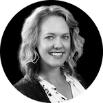 Headshot of Sarah Howes, a woman with blonde hair, captured in a striking black and white photograph.