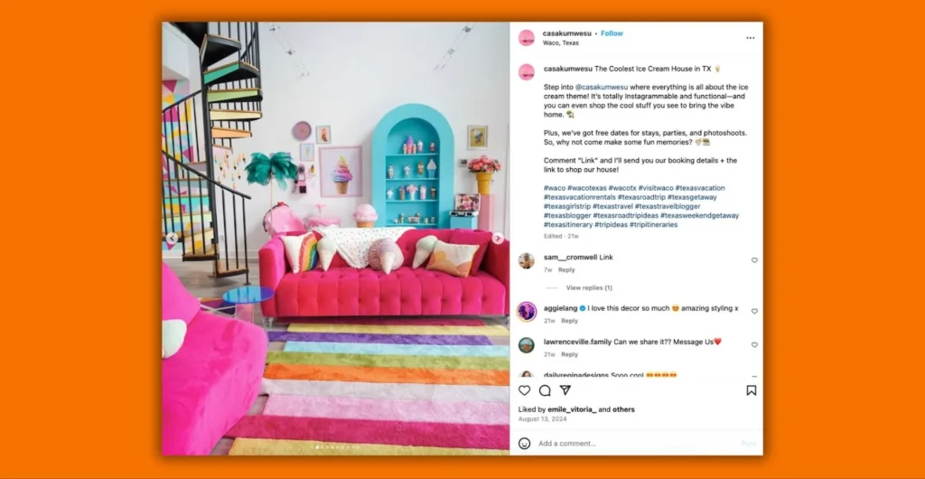 Colorful living room with a pink sofa, multicolored rug, and pastel blue arched alcove with ice cream decor.