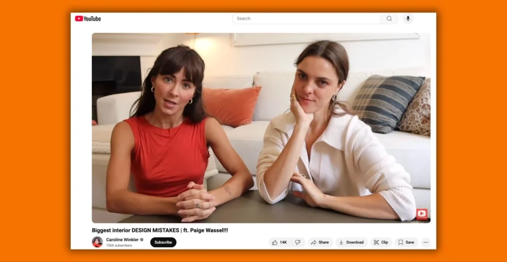 Two women are seated in a well-lit room, discussing interior design tips, with a sofa and decorative pillows in the background.