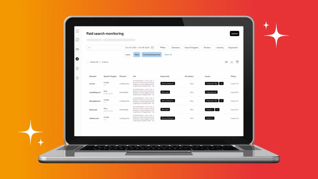 A laptop displaying a paid search monitoring dashboard, featuring data on domains, search engines, ads, keywords, and issues.