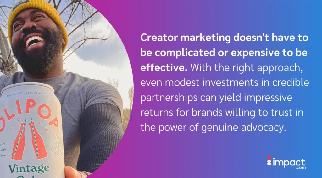 A person holds a can of OLIPOP Vintage Cola outdoors, surrounded by trees under a cloudy sky, emphasizing creator marketing effectiveness.