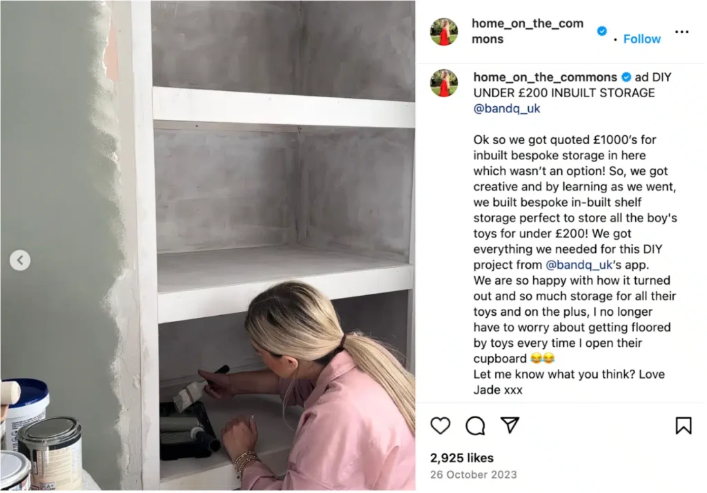 A person is painting a white inbuilt shelf unit with gray walls and various paint supplies visible nearby.