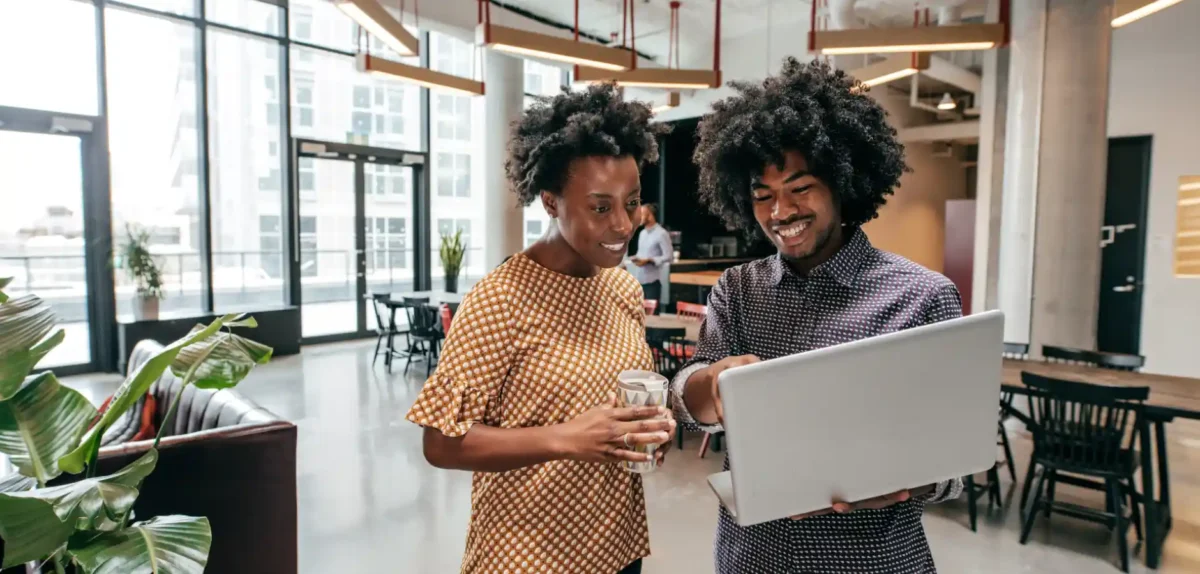 Two people looking at a laptop