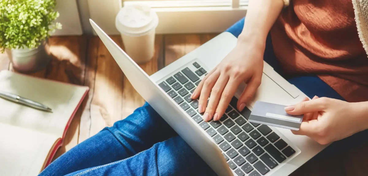 Person with credit card shopping online