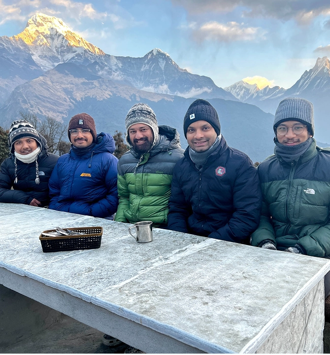 impact.com team members at the top of a mountain