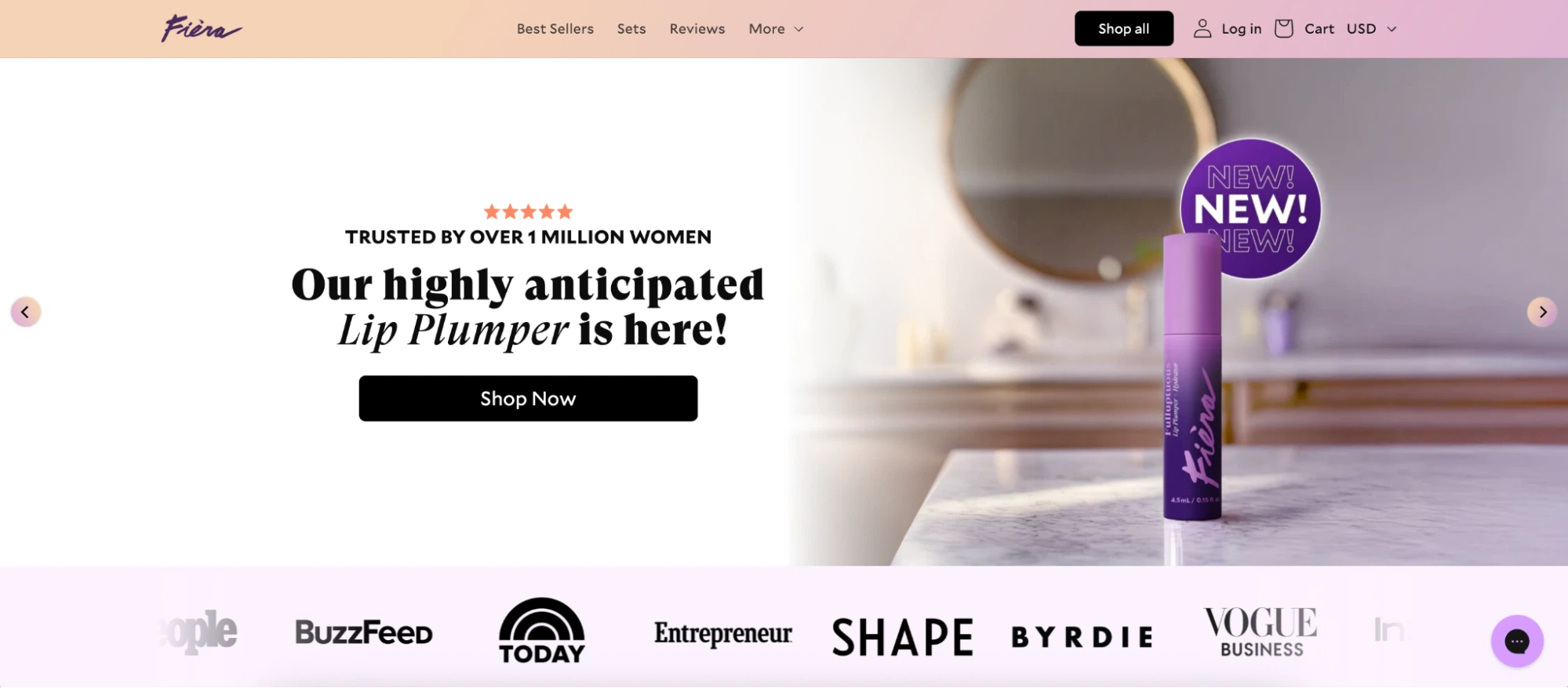 A vibrant Lip Plumper from Fiera on a marble countertop with promotional text about its launch and trust from over a million women.