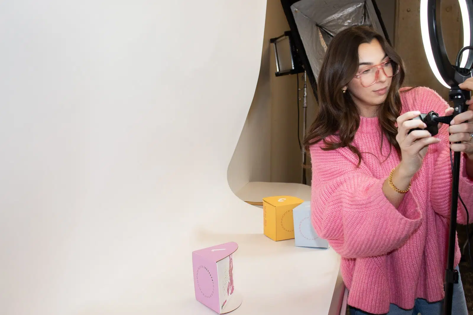 A woman capturing a moment with a camera, focused on her photography in an outdoor setting.