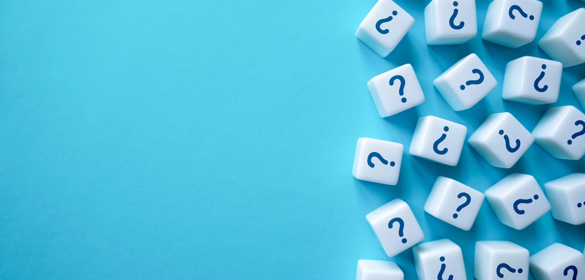White dice with blue question marks scattered on a blue background, leaving empty space on the left side.