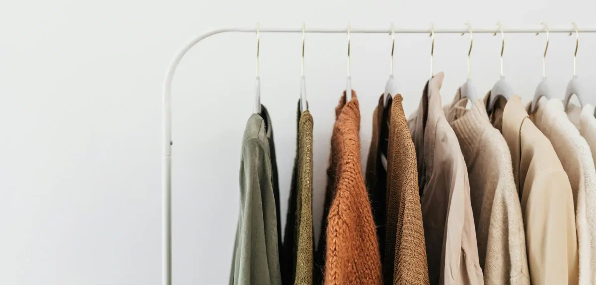 A clothing rack displaying a variety of shirts in multiple colors, showcasing different styles and designs.