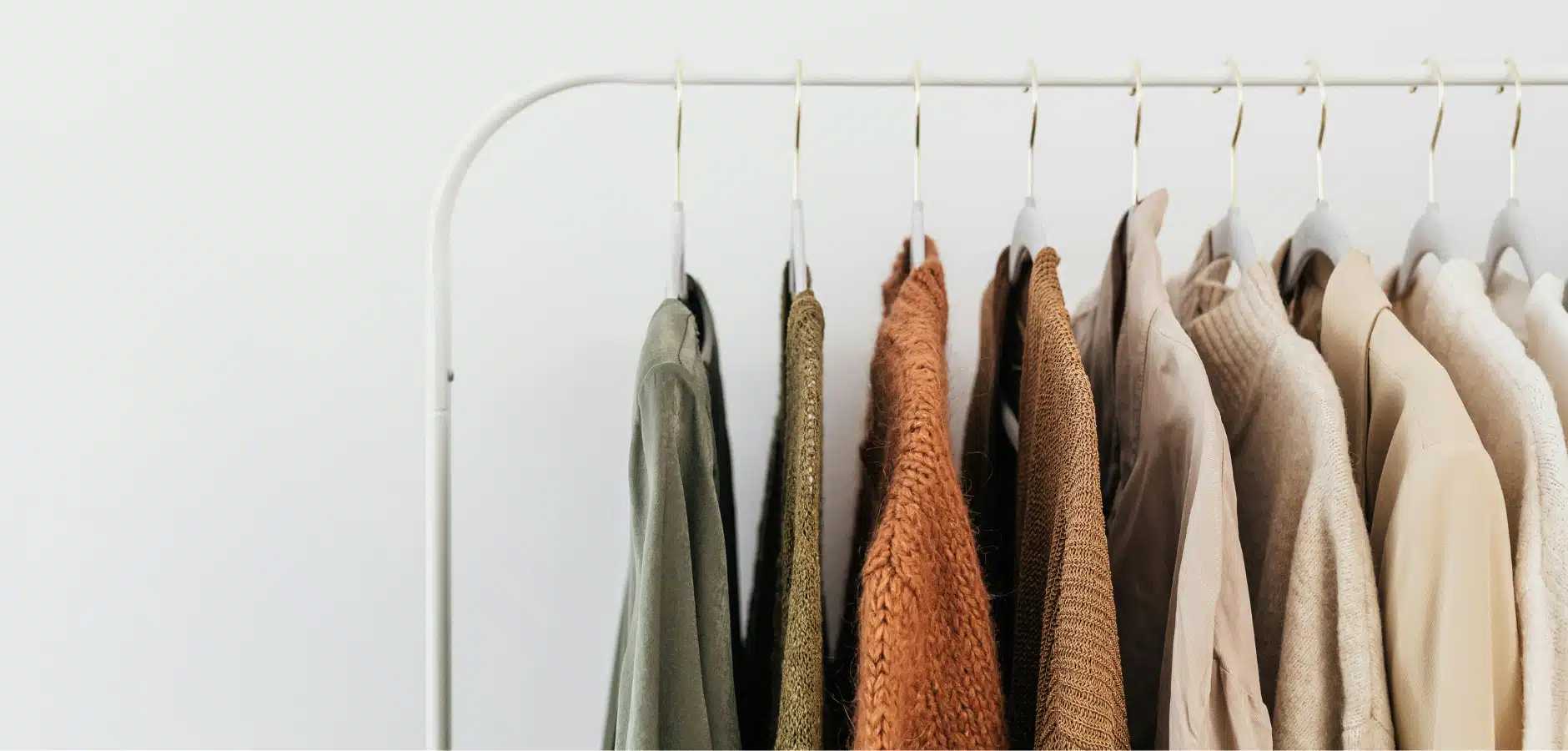 A clothing rack displaying a variety of shirts in multiple colors, showcasing different styles and designs.